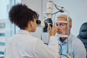 Doctor administering glaucoma eye exam to patient